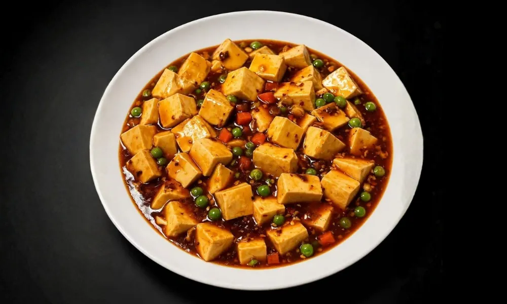 Mapo tofu with peas and carrots in spicy red sauce