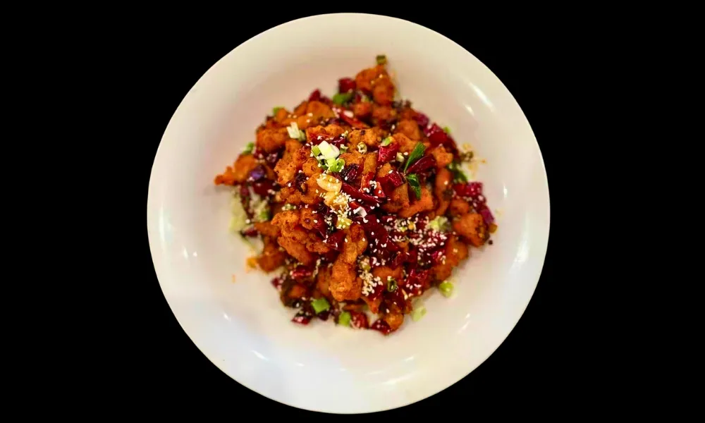 Spicy diced chicken stir‑fried with dried chili and sesame