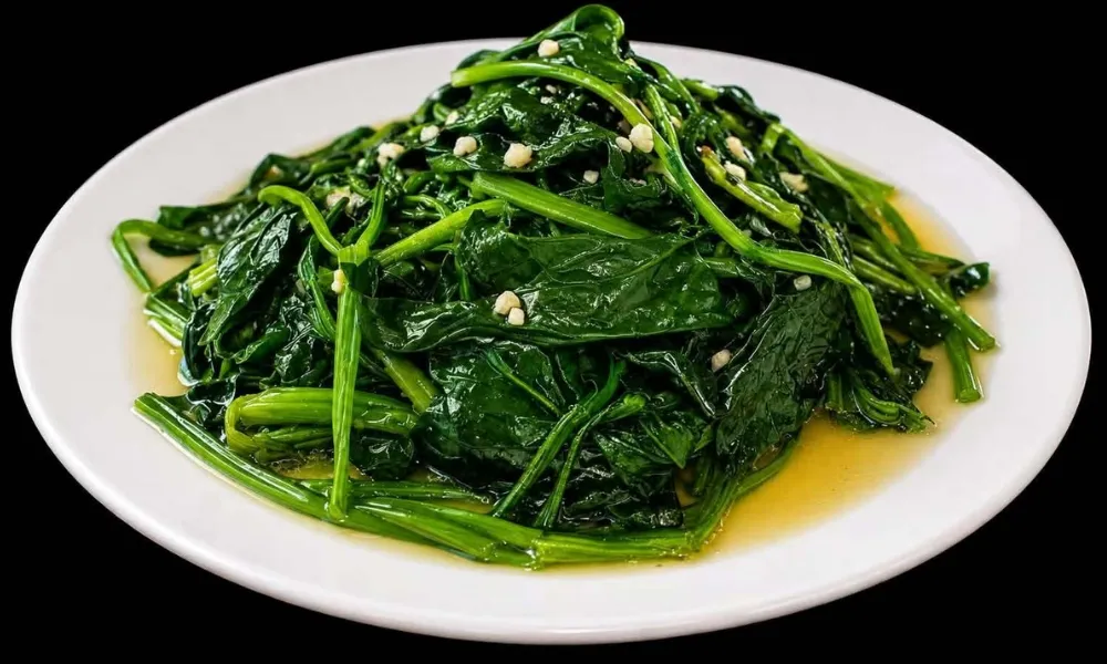 Stir‑fried spinach with minced garlic on white plate